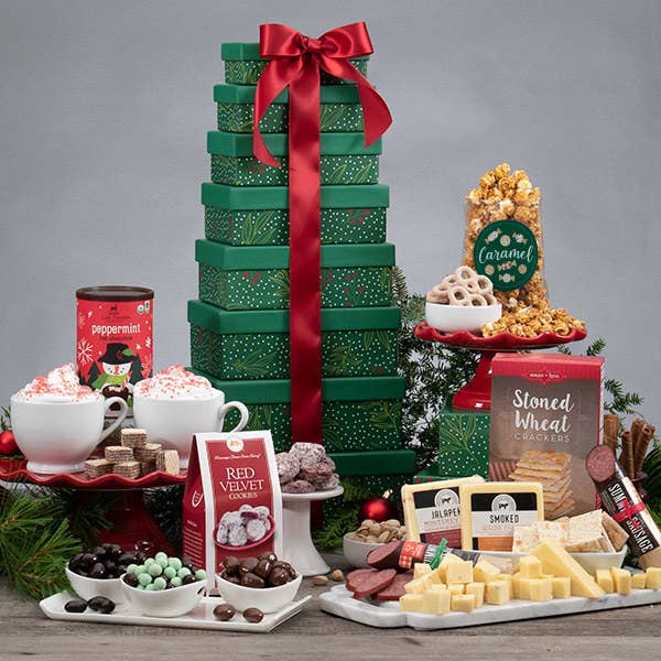 Christmas tree colored boxes stacked with red ribbon. All treats around packaging. 