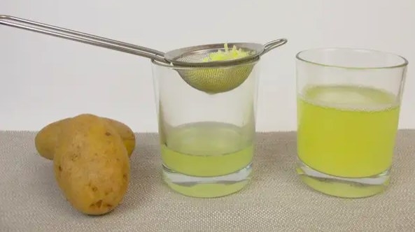 Picture of potato next to two glasses filled with potato water