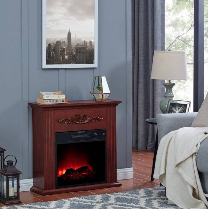 Mahogany electric fireplace against gray wall