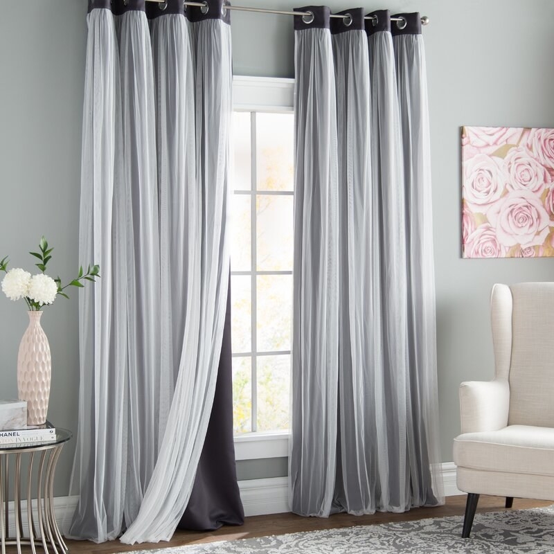 a set of grey black out curtains in a living room