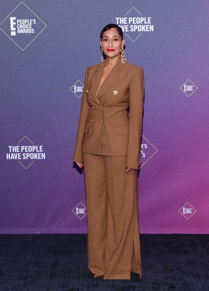 Tracee Ellis Ross wears a structured pantsuit with statement earrings 