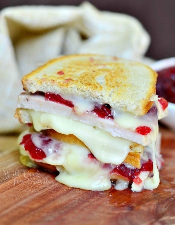 Two halves of a turkey, cranberry, and Brie grilled cheese stacked.