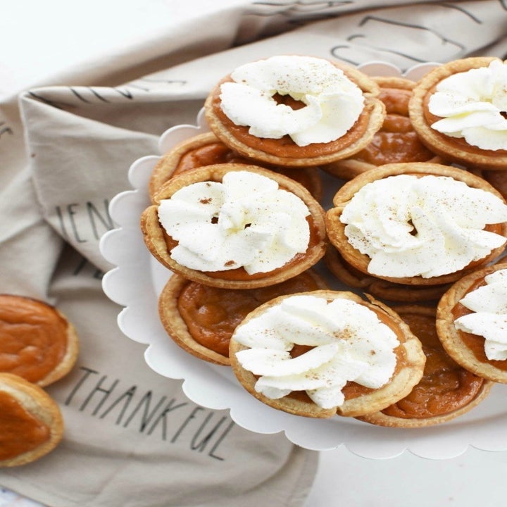 Mini pumpkin pies topped with whipped cream.