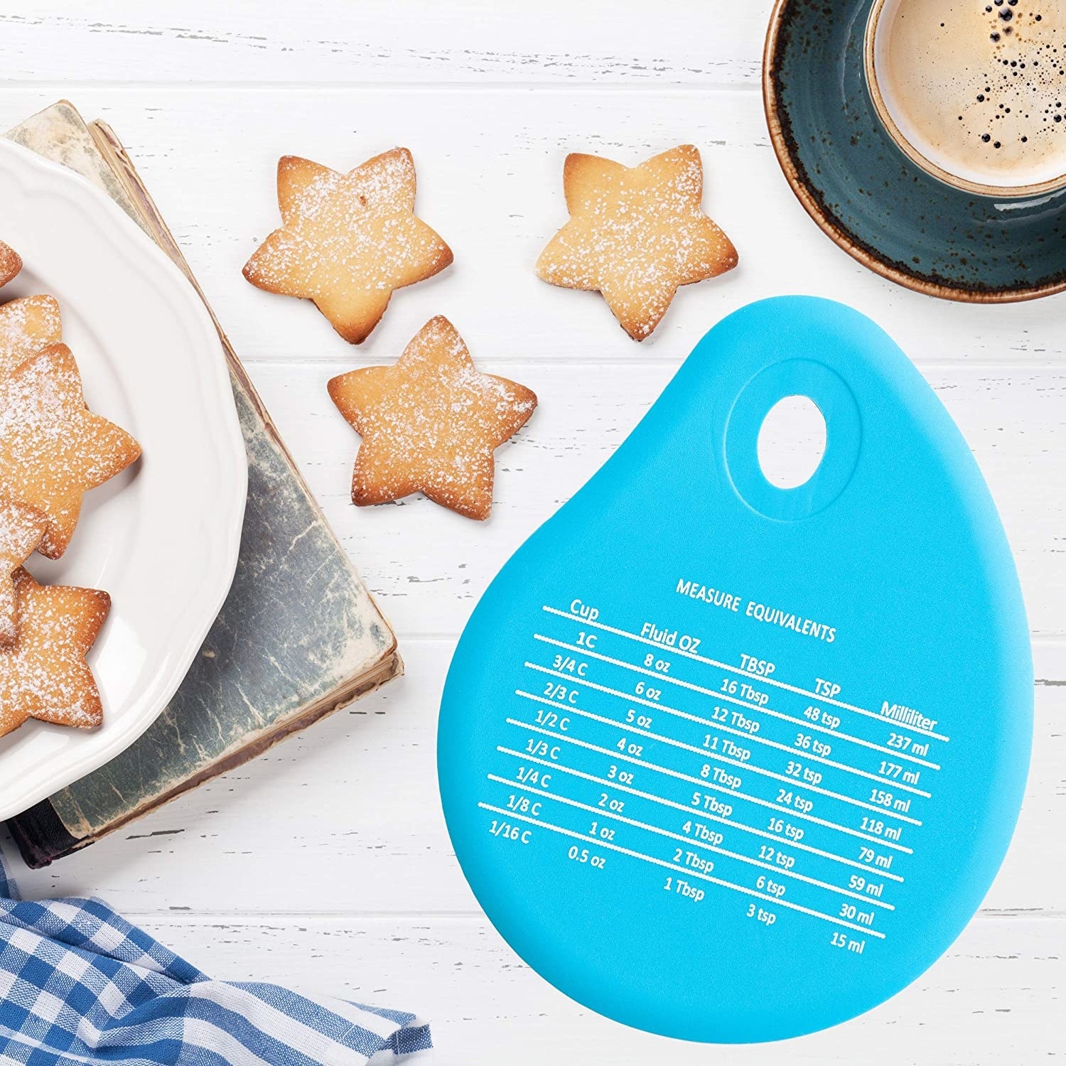 A silicone spatula next to star-shaped sugar cookies