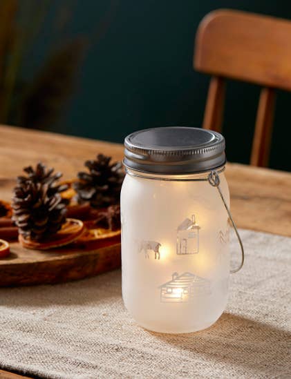 A mason-jar inspired table lantern with rustic designs