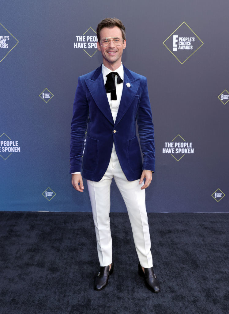 Brad Goreski wears a jacket over a top and matching pants