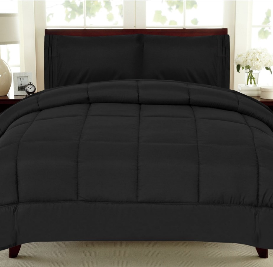 Black down comforter on bed