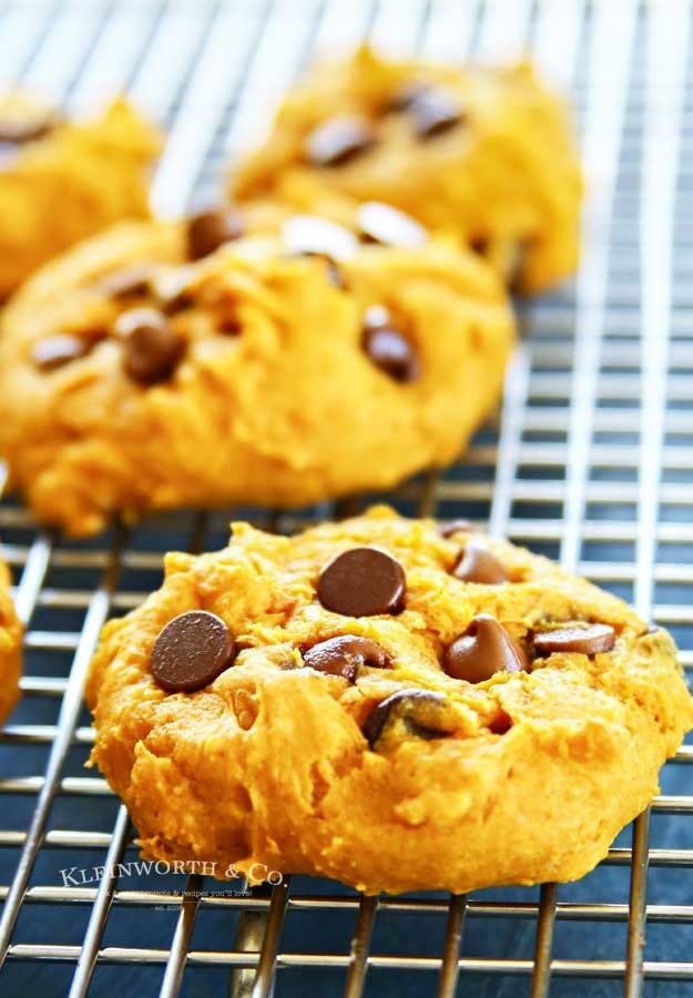 A handful of pumpkin chocolate chip cookies on a cooling rack.