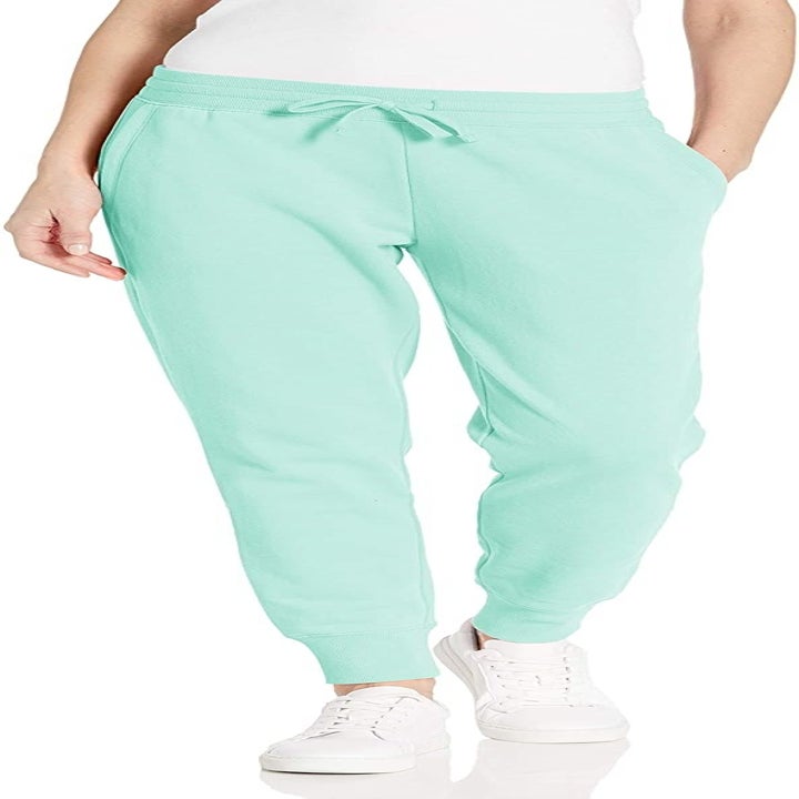 A model wearing the mint green sweats with a hand in one of the side pockets
