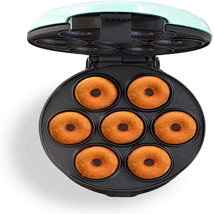 The mini donut maker in aqua with seven donuts baking