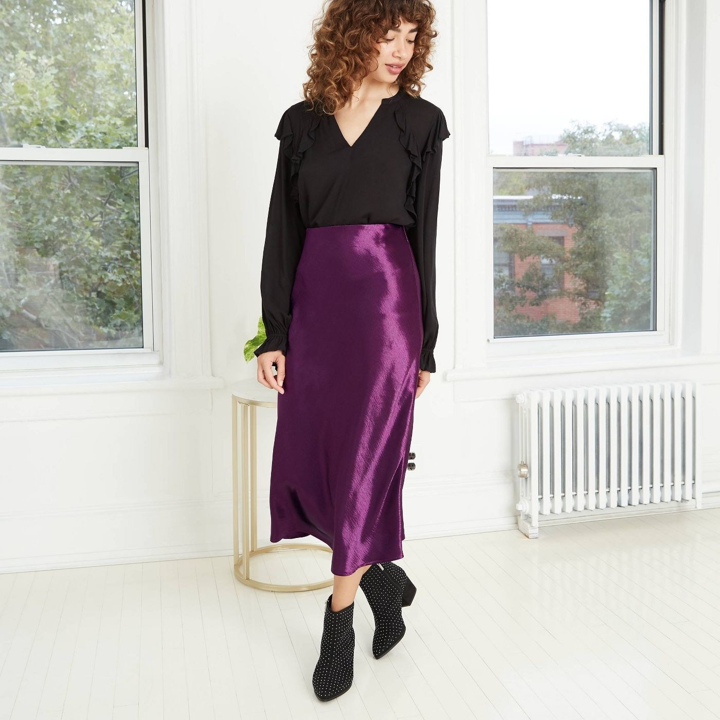 Moden in purple silky maxi skirt and black top