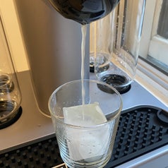Bartesian cocktail machine pouring a cocktail into a glass