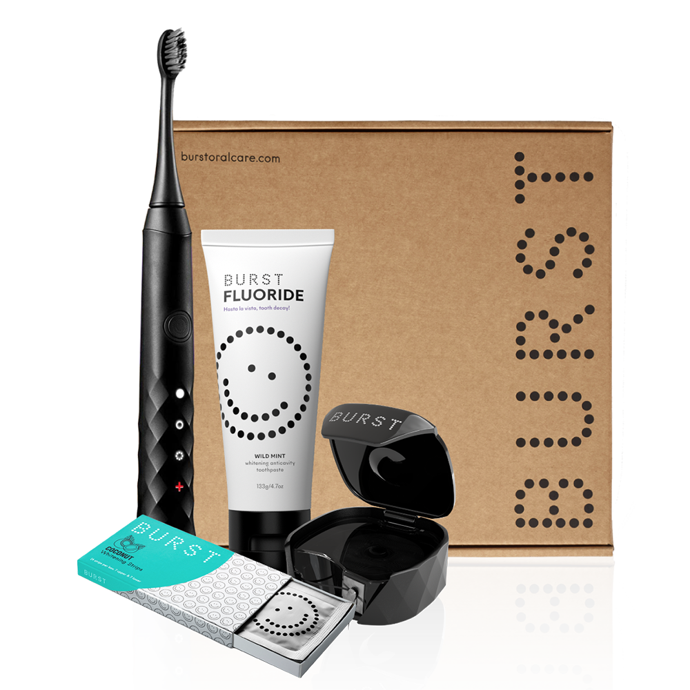 Black electric toothbrush, tube of fluoride toothpaste, pack of whitening strips, refillable floss