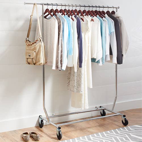 The metal rack holding several pieces of clothing