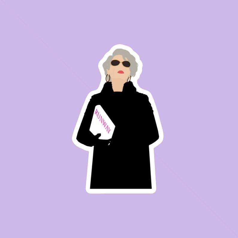 the sticker of Miranda Priestly wearing black sunglasses and holding a copy of &quot;runway&quot; magazine 