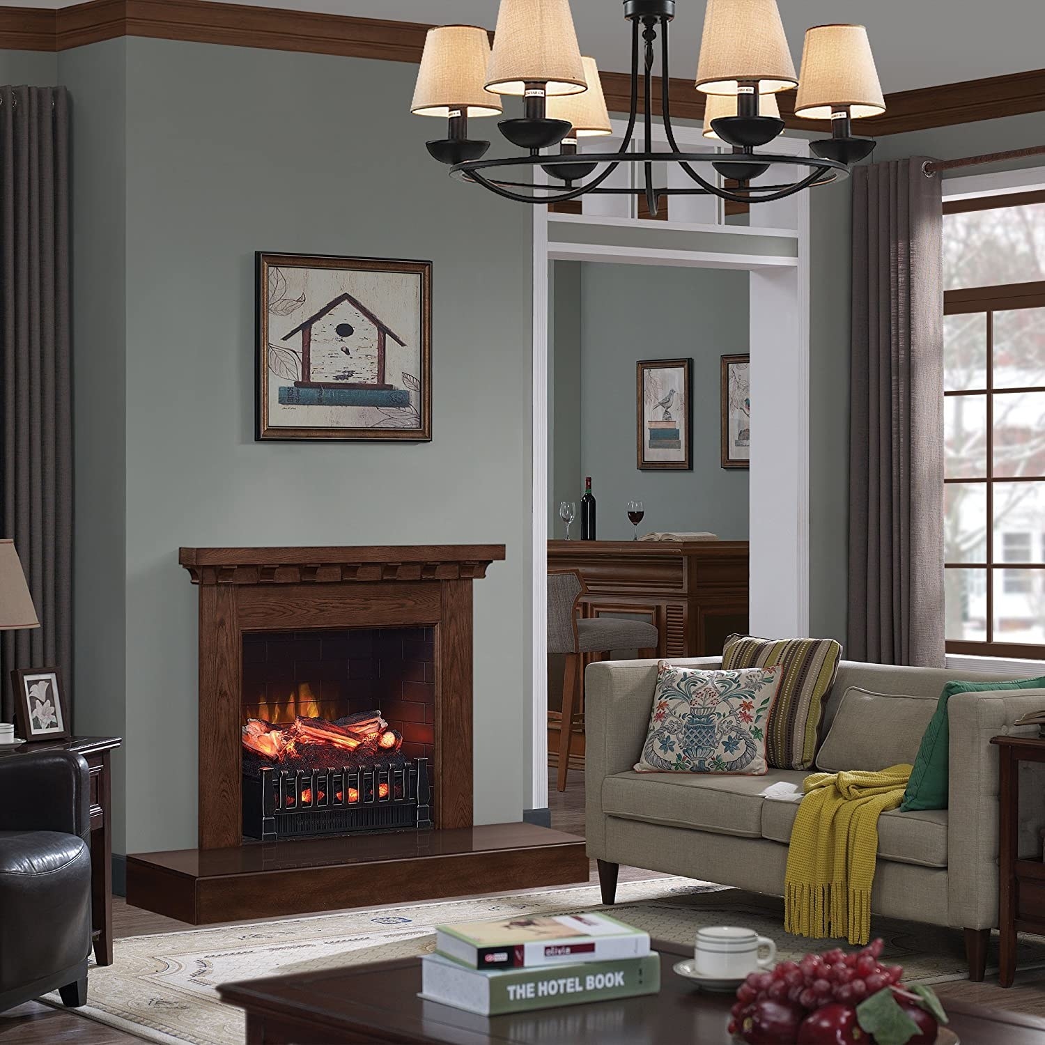 Electric fireplace in front of living room decorated with a cozy gray couch, armchair, and coffee table