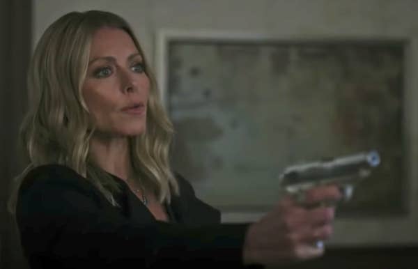Kelly holding a gun