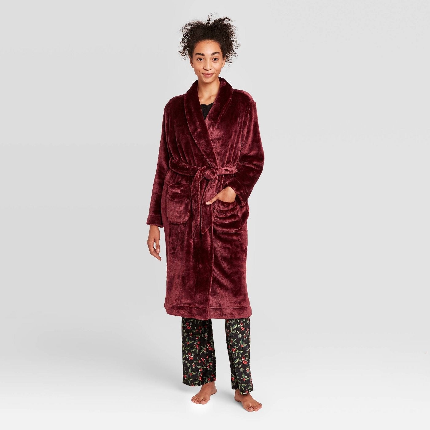 The plush robe warn by a model in a deep red