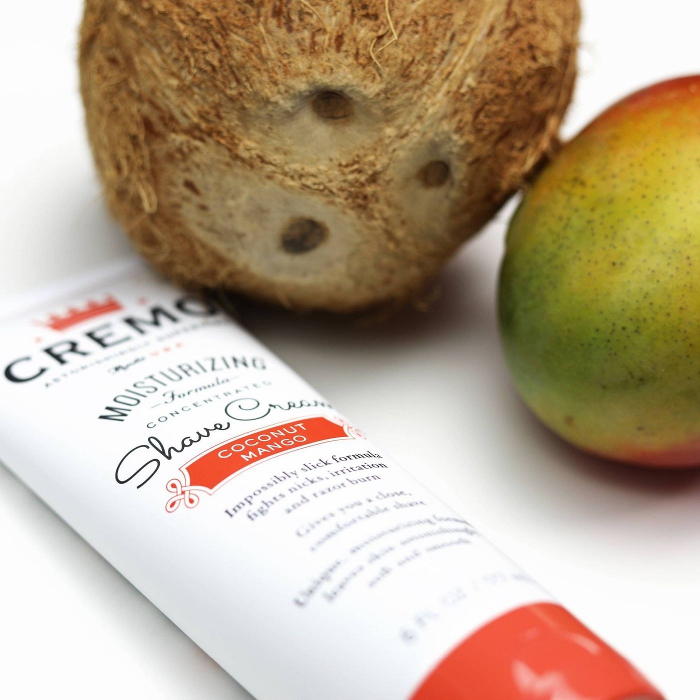 The shaving cream beside a coconut and mango