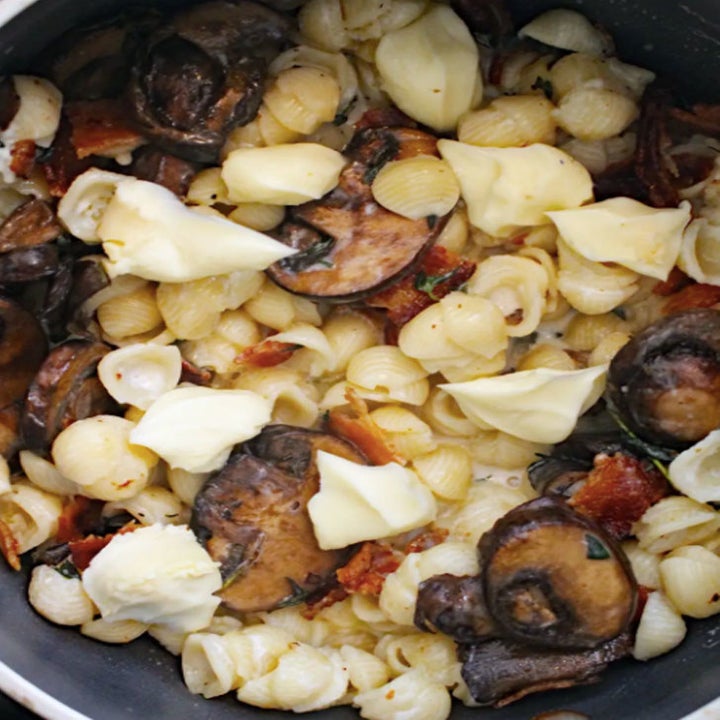 A bowl of mac 'n' cheese with brie, mushrooms, and thyme.