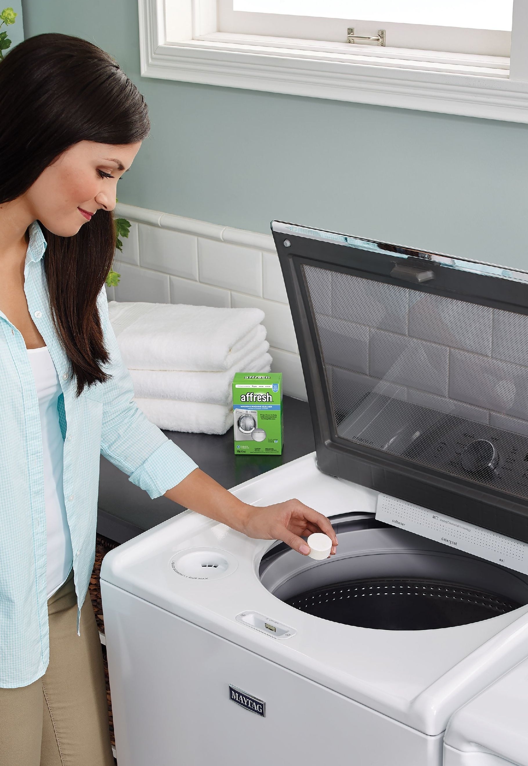 Model uses a white machine cleaning tablet from the green box