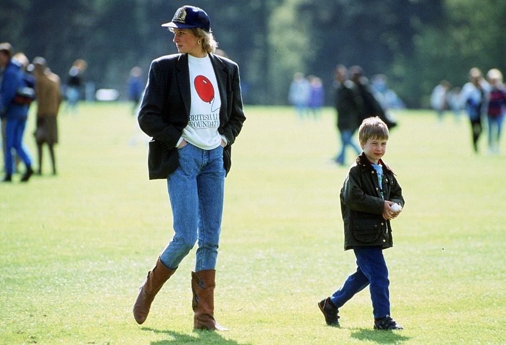 Princess Diana walking with a young Prince William