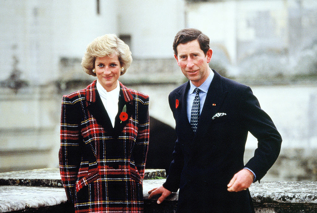 Princess Diana in a blazer with a poppy pin posing next to Prince Charles