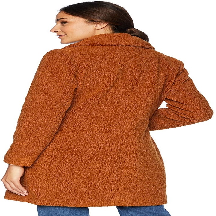 View of the same model in the cognac coat from the back
