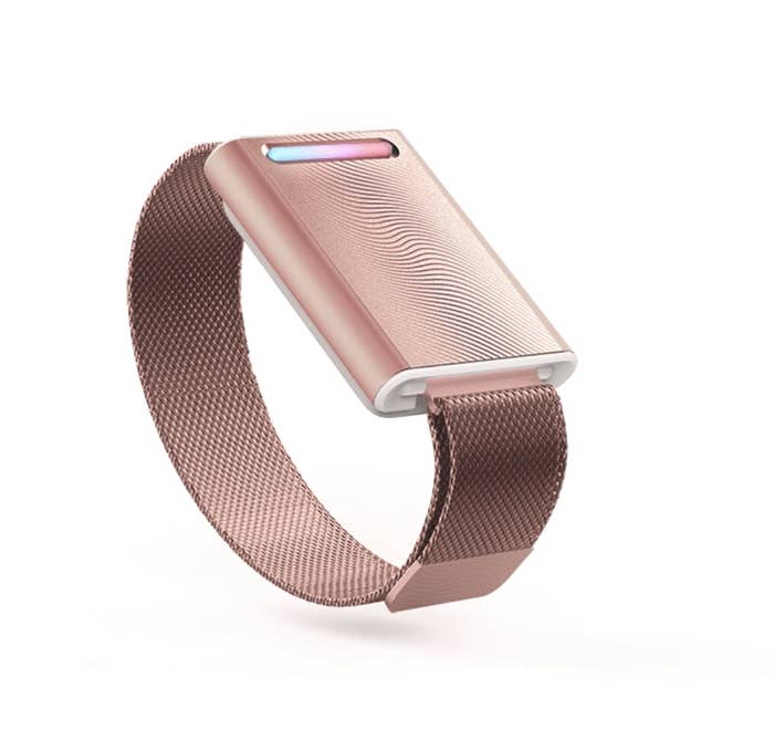 A rose gold metallic bracelet with a square head