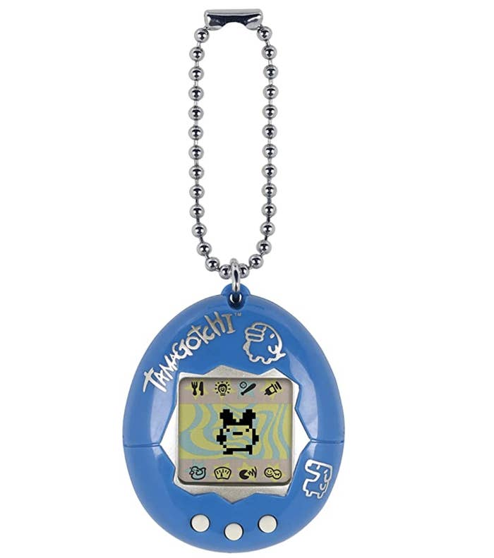 A tamagotchi handheld device with a character in the center of its screen