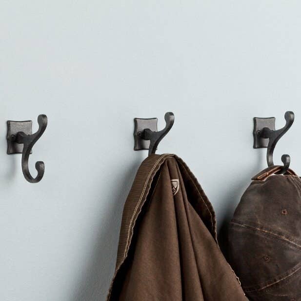 Three gunmetal, double-scroll hooks