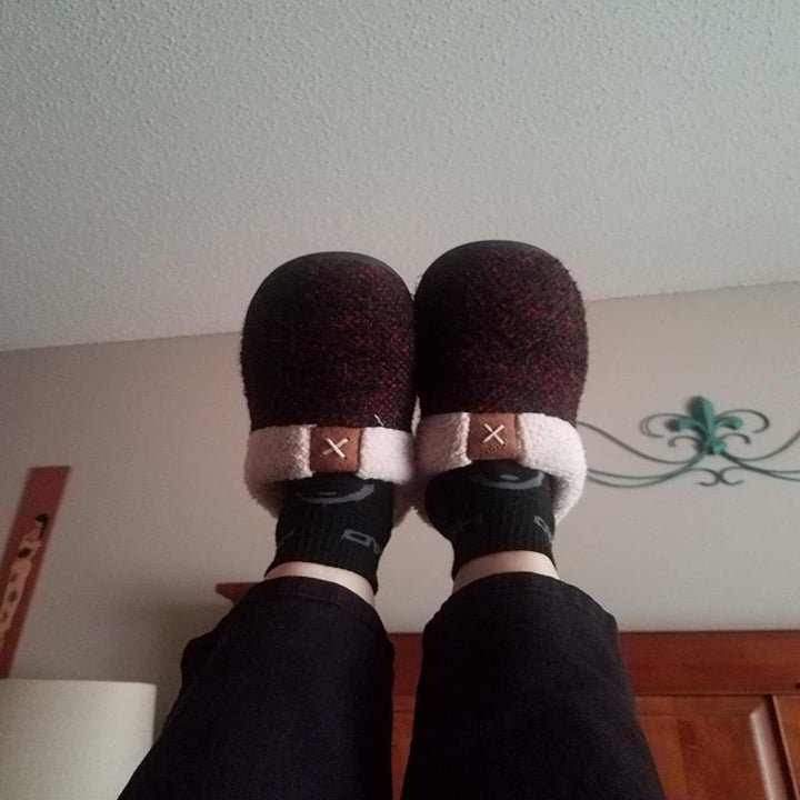 Reviewer wears red anti-skid slippers while lounging in sweatpants