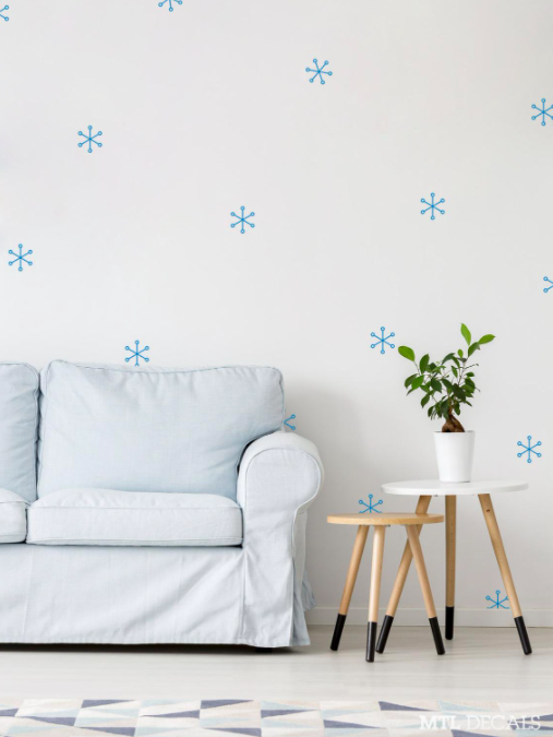 A series of snowflake-shaped decals on a living room wall