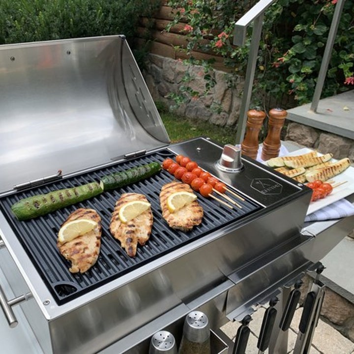 three pieces of chicken and veggies on the grill