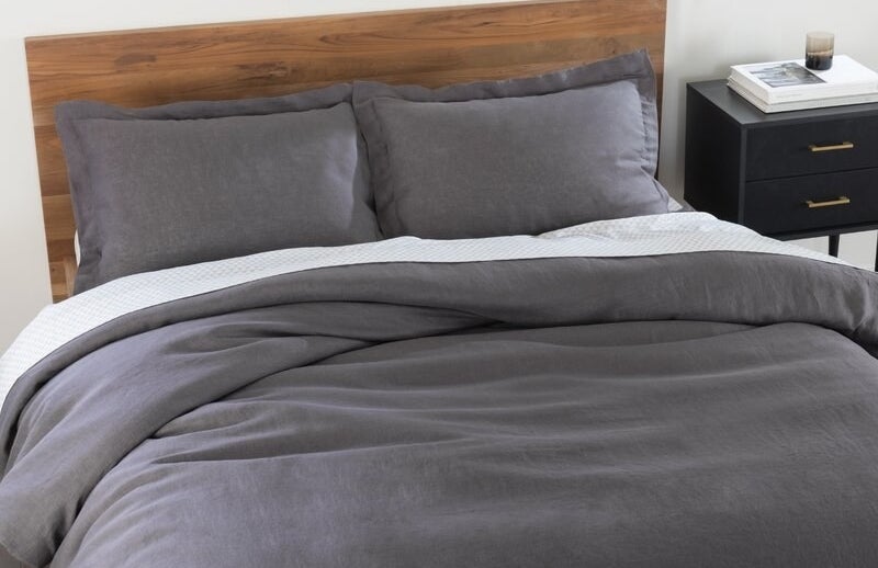 grey duvet cover and pillow shams on a bed