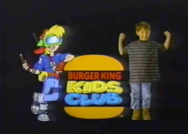 A screenshot of the cartoon mascot for the Burger King Kids Club standing next to a kid and the logo.