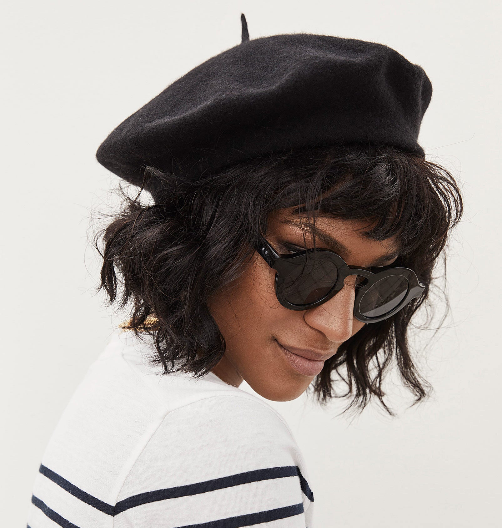 A person wearing the beret and sunglasses