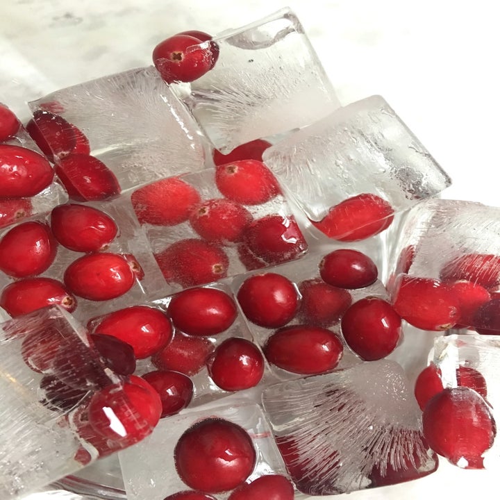 Putting cranberries in ice cubes