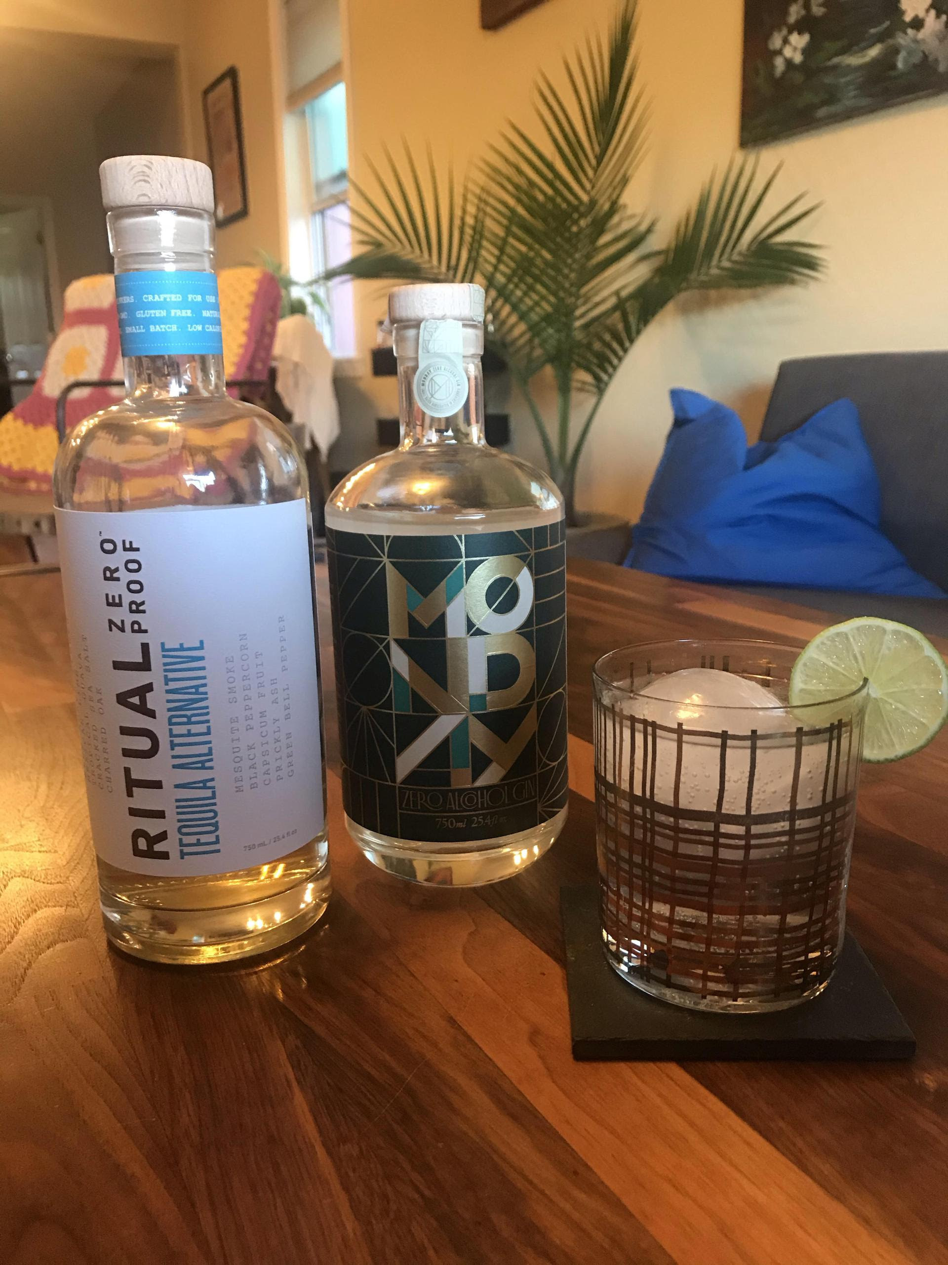 bottles of the non-alcoholic tequila and gin next to a mocktail
