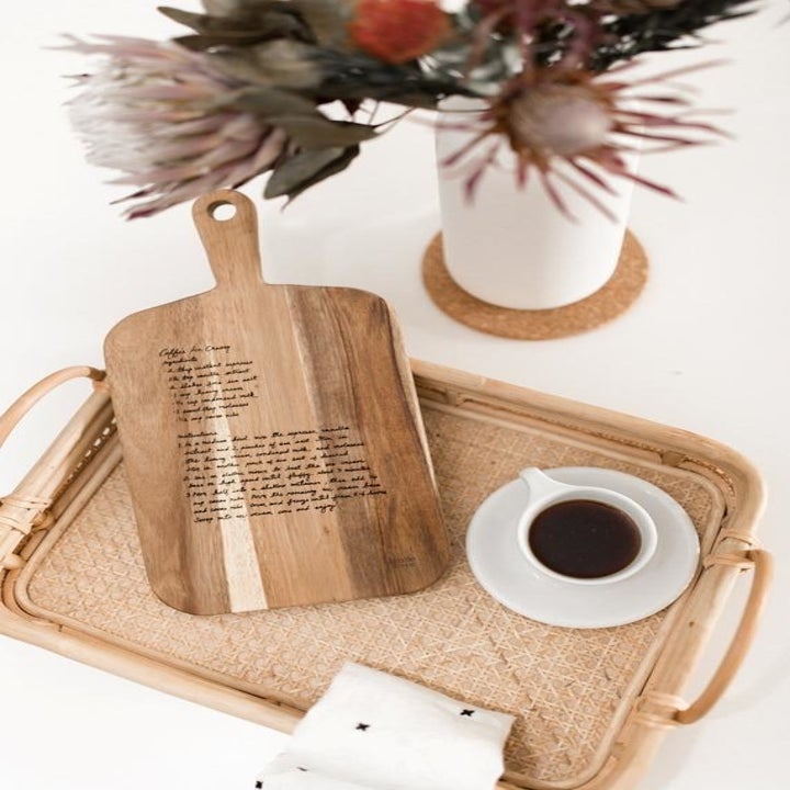 A personalized cutting board displayed on a tray