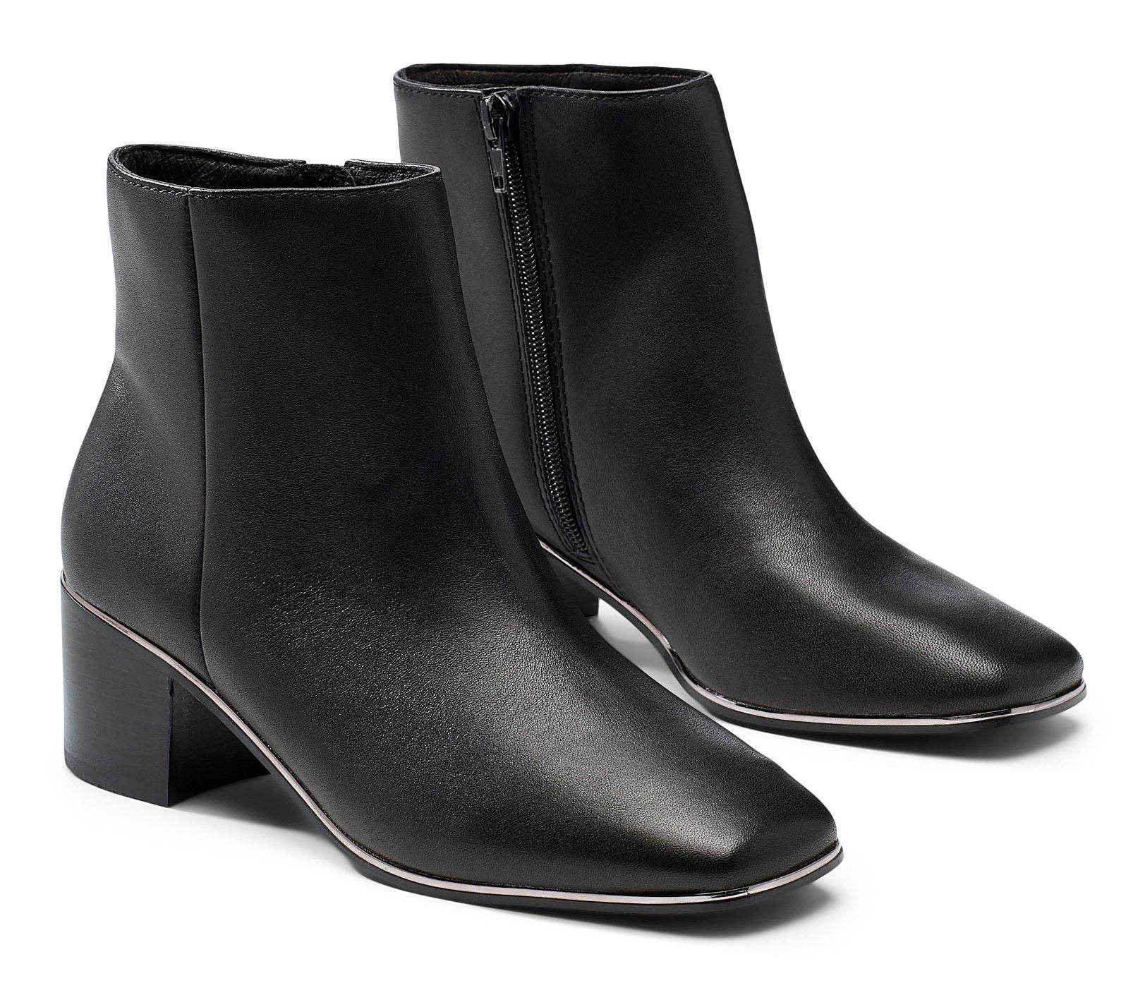 A pair of leather Chelsea boots on a plain background