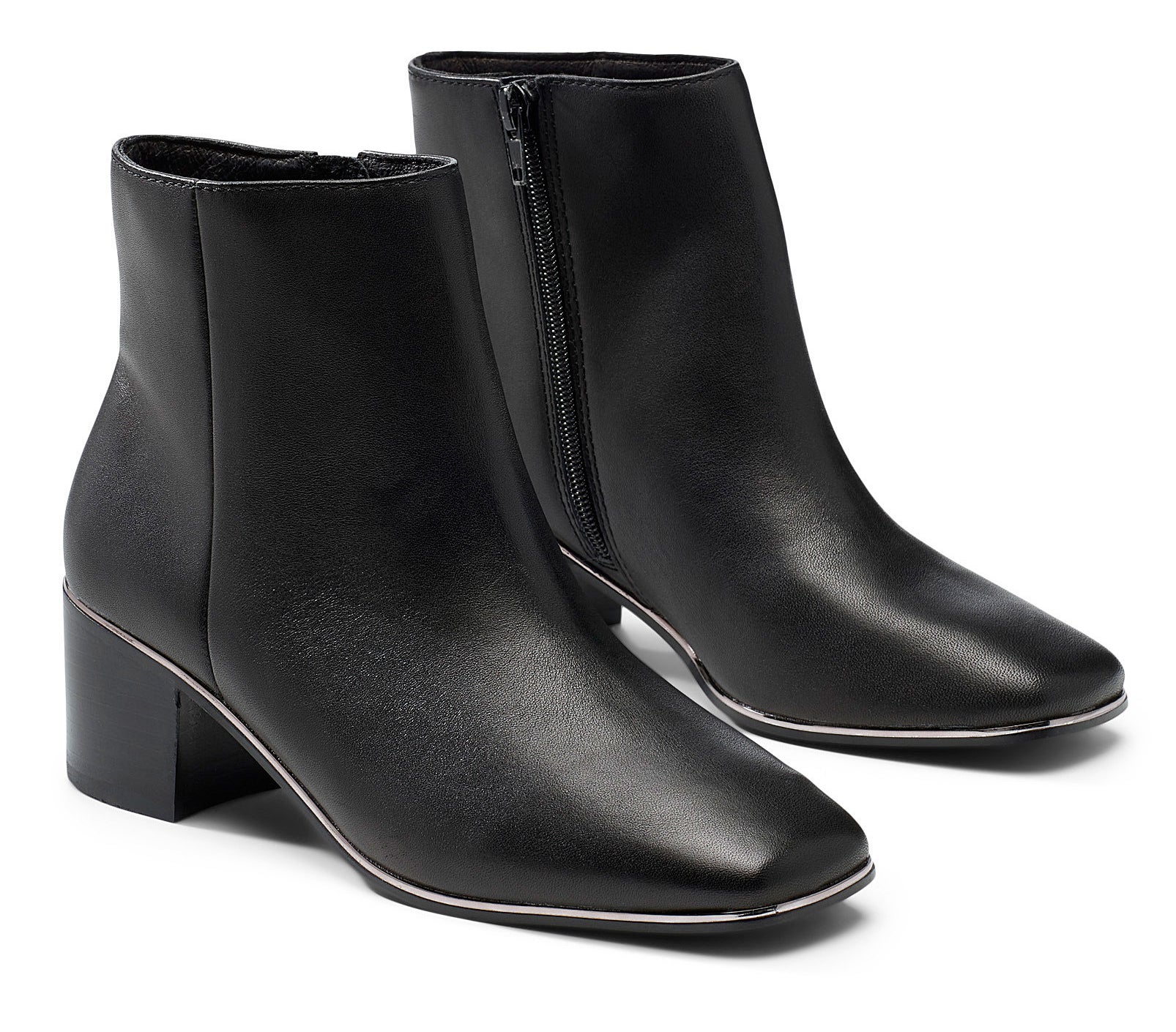 A pair of leather Chelsea boots on a plain background