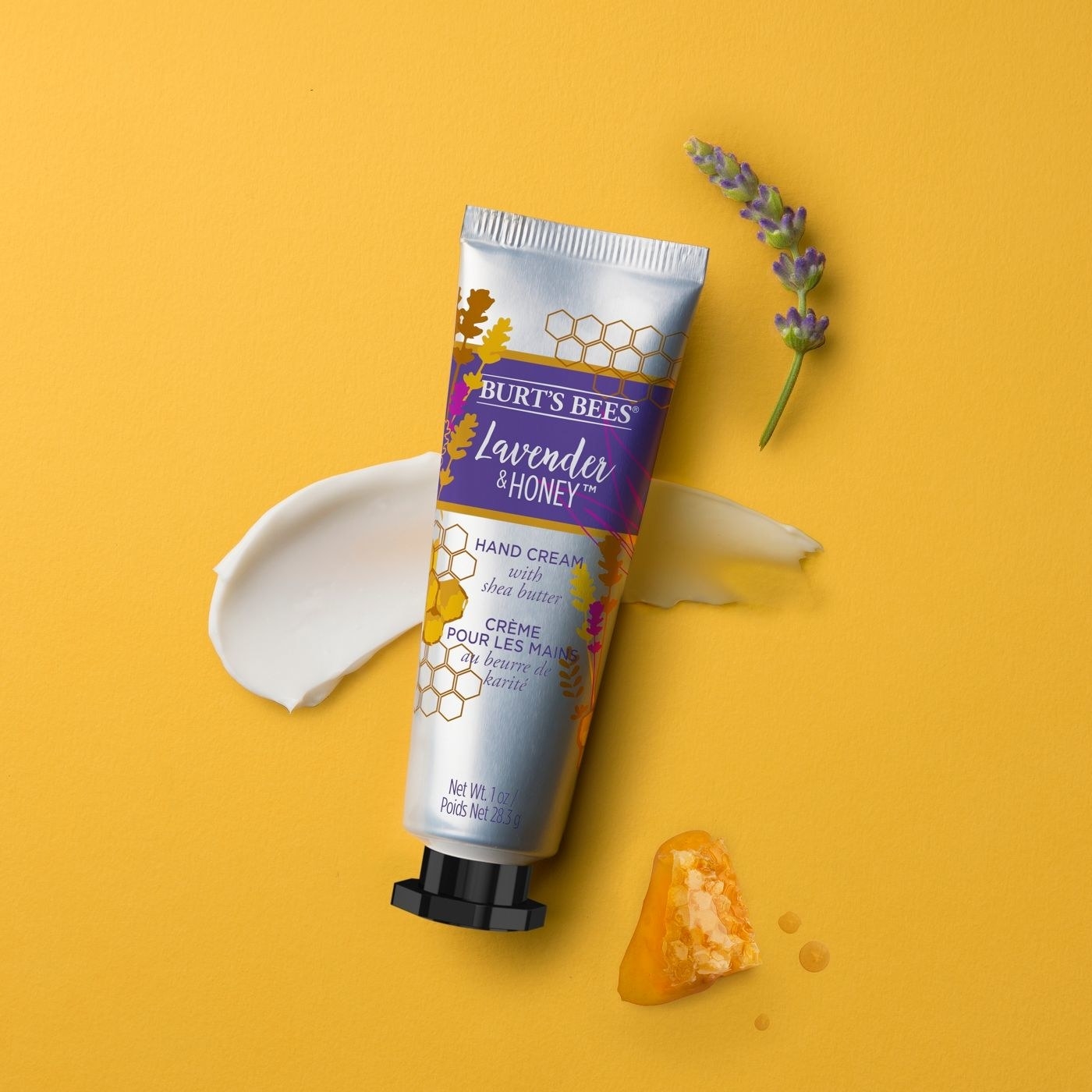 The tube of hand cream in front of a swatch of the product to show its texture and consistency