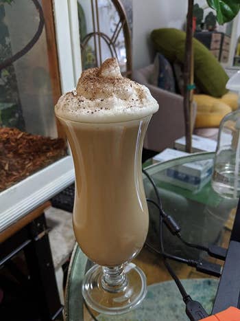reviewer's tall glass filled with espresso and frothy milk