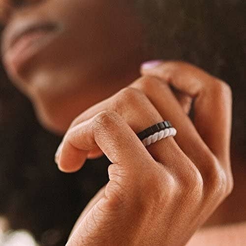 A close up of a person wearing two stackable silicone rings