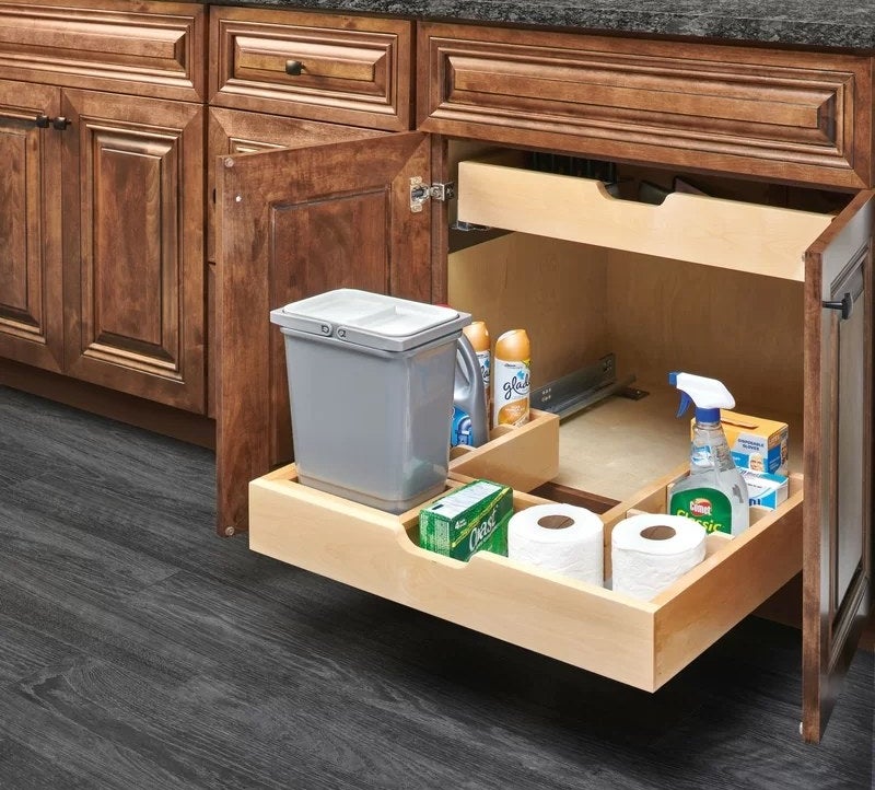 The compartmentalized, U-shaped drawer under a kitchen sink