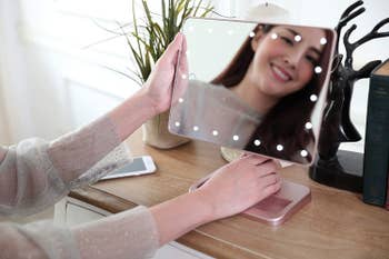 Model looking into lighted mirror turned sideways