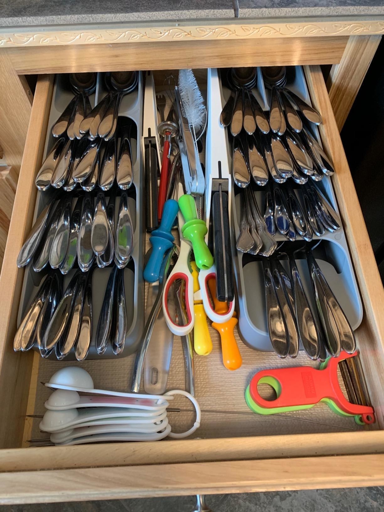 a neatly organized drawer with the utensils