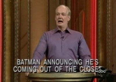 Colin at a podium with text reading, &quot;Batman announcing he&#x27;s coming out of the closet&quot;