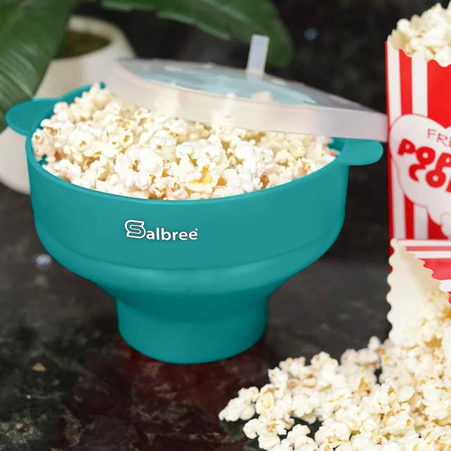 a blue silicone bowl with popcorn in it